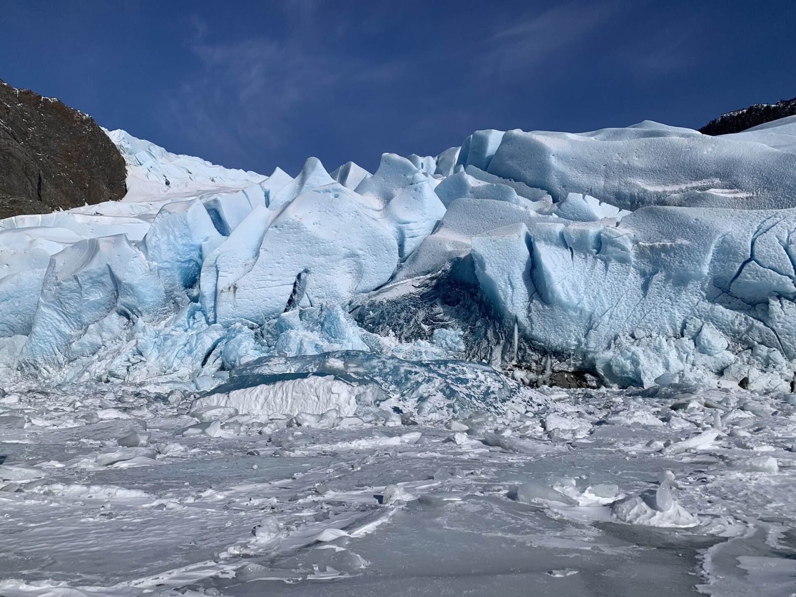 Close view of blue, fractured ice at the face of Mendenhall Glacier
