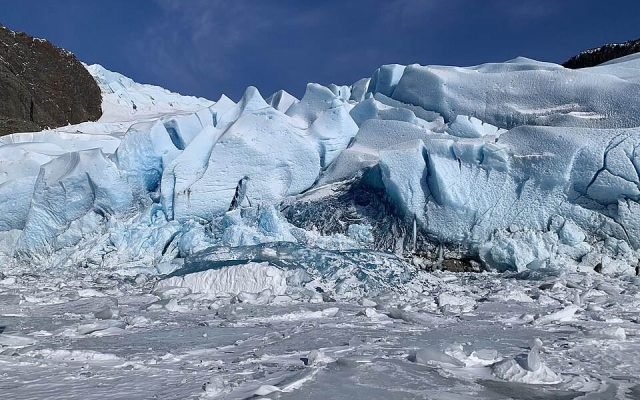 Close view of blue, fractured ice at the face of Mendenhall Glacier