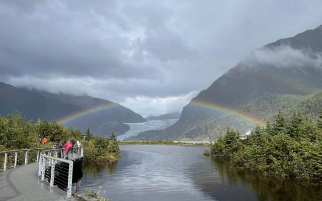 Visitors on the Photo Point walkway as a double rainbow arcs over the glacier and lake